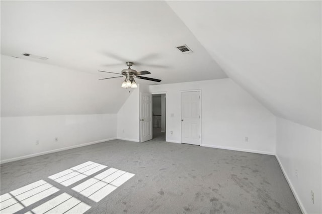 bonus room featuring lofted ceiling, carpet flooring, visible vents, and baseboards