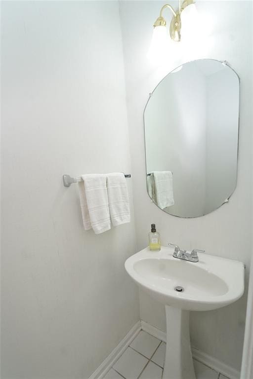 bathroom with baseboards and tile patterned floors