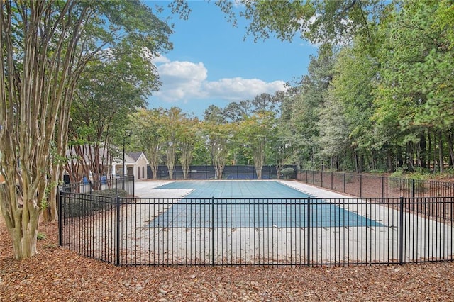 pool with a patio and fence