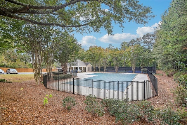 pool with a patio and fence