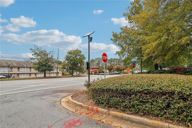 view of road with curbs and traffic signs