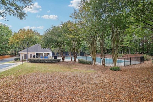 exterior space featuring fence and a community pool