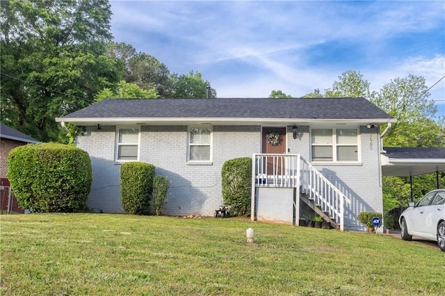 view of front of property with a front lawn and a carport