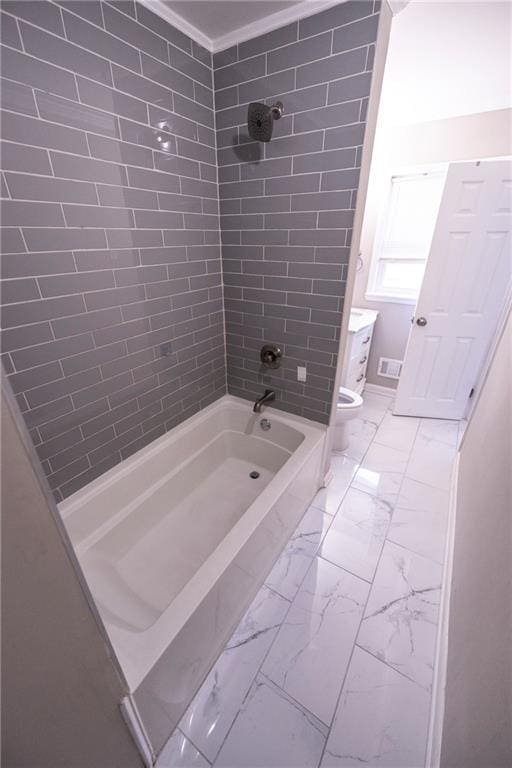 bathroom with crown molding, tiled shower / bath combo, and toilet