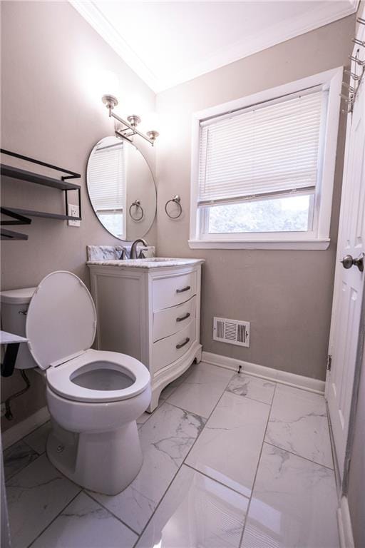 bathroom featuring ornamental molding, vanity, and toilet