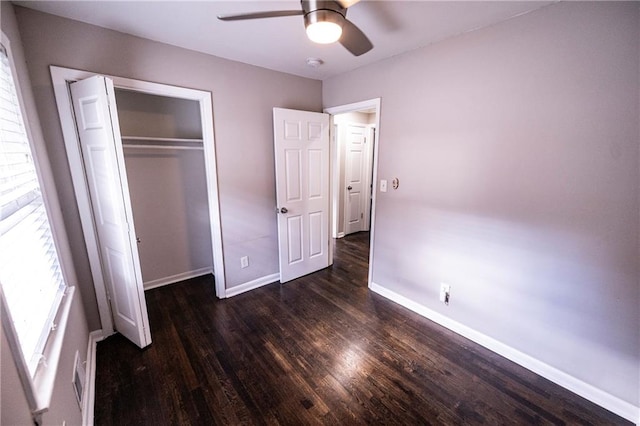 unfurnished bedroom with ceiling fan, a closet, and dark hardwood / wood-style floors