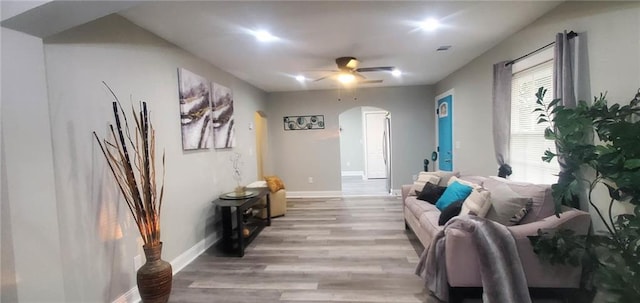 3046 Dobbs Way, East Point, GA 30344 - living area with arched walkways, light wood-style floors, a ceiling fan, and baseboards
