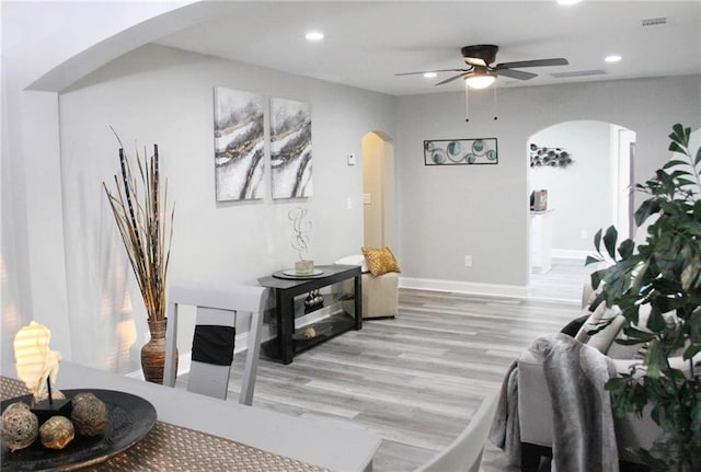 3046 Dobbs Way, East Point, GA 30344 - living room featuring arched walkways, light wood-style flooring, ceiling fan, recessed lighting, and baseboards