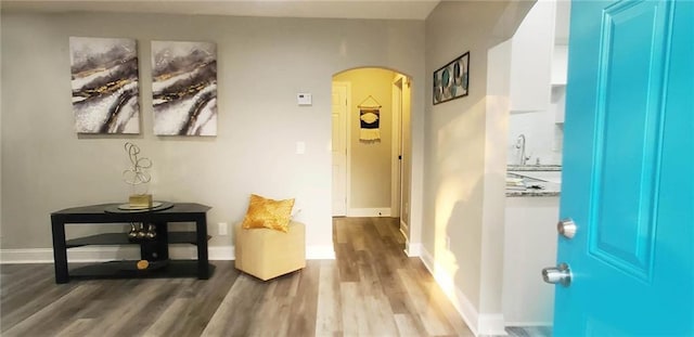 3046 Dobbs Way, East Point, GA 30344 - corridor with arched walkways, wood finished floors, a sink, and baseboards