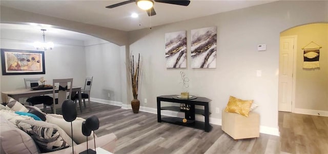 3046 Dobbs Way, East Point, GA 30344 - living room with arched walkways, wood finished floors, a ceiling fan, and baseboards