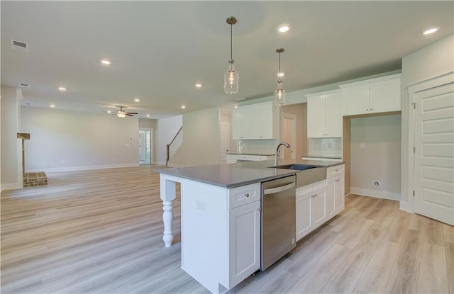 18 Slick Ct, Senoia, GA 30276 - kitchen with stainless steel dishwasher, white cabinets, a ceiling fan, light wood-style flooring, and recessed lighting