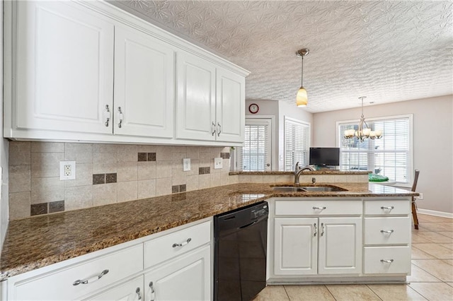 kitchen featuring dishwasher, dark stone countertops, kitchen peninsula, sink, and white cabinets