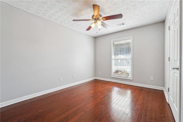 unfurnished room featuring ceiling fan, a textured ceiling, and dark hardwood / wood-style flooring