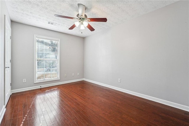 spare room featuring a textured ceiling, ceiling fan, and hardwood / wood-style floors