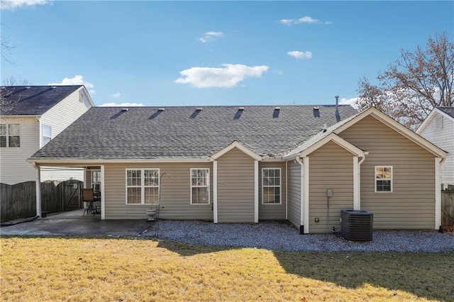 rear view of property featuring a lawn and a patio