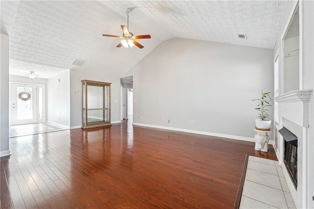 unfurnished living room featuring a textured ceiling and wood-type flooring