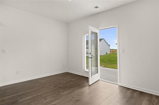 spare room with dark hardwood / wood-style floors