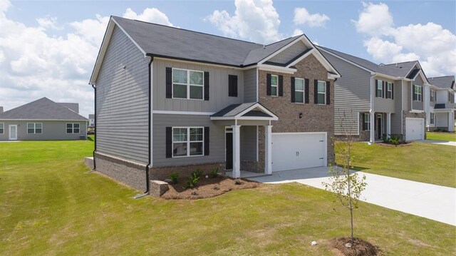 view of front of home featuring a garage and a front yard