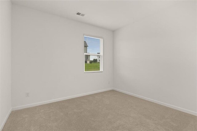 unfurnished room with light carpet