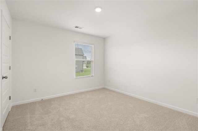 unfurnished room featuring light colored carpet