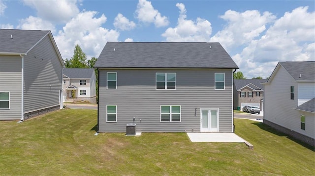 rear view of house featuring central AC, a patio area, and a yard