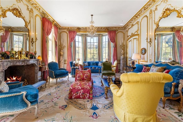 living area with a premium fireplace, an inviting chandelier, crown molding, and a wealth of natural light