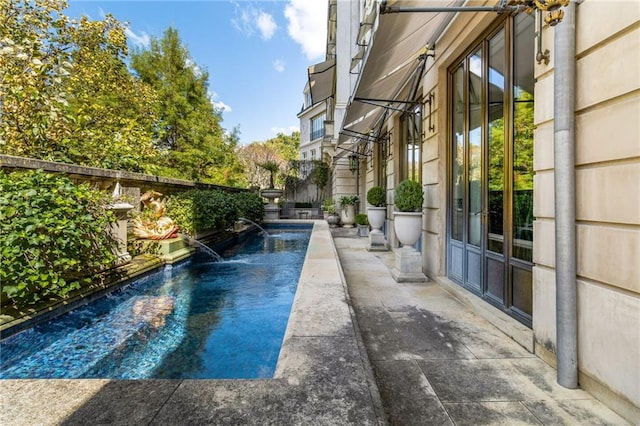 view of pool featuring a patio area and pool water feature