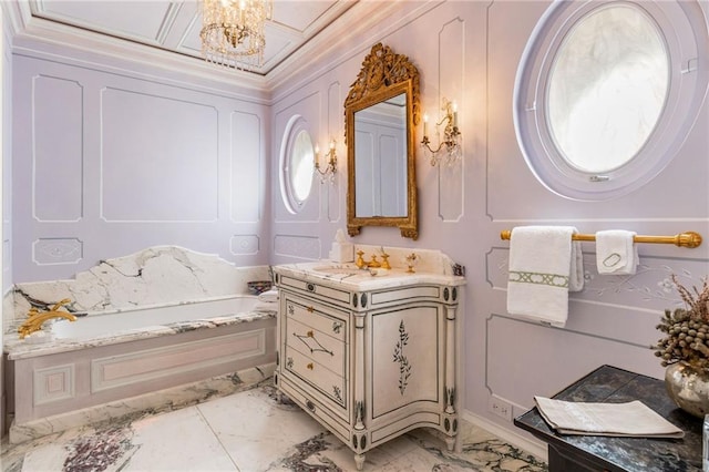 bathroom with vanity, a notable chandelier, and a tub to relax in