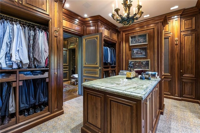 walk in closet with an inviting chandelier