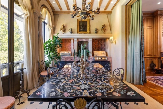 dining space with parquet floors, beamed ceiling, and a chandelier