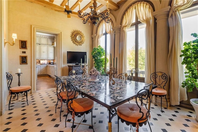 dining space with beamed ceiling, a chandelier, and light hardwood / wood-style flooring