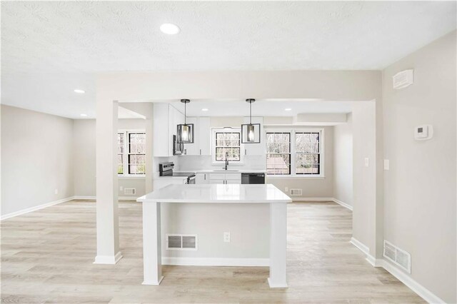 2167 Cedar Dr, Lawrenceville, GA 30043 - kitchen with a sink, stainless steel appliances, light wood-style floors, and light countertops