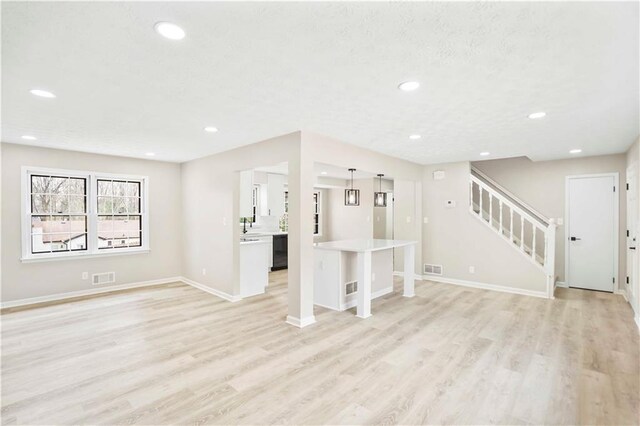 2167 Cedar Dr, Lawrenceville, GA 30043 - kitchen featuring white cabinetry, light wood-style flooring, baseboards, and visible vents