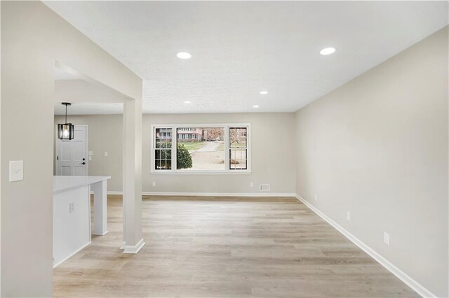 2167 Cedar Dr, Lawrenceville, GA 30043 - unfurnished living room featuring light wood finished floors, a brick fireplace, baseboards, and a tray ceiling