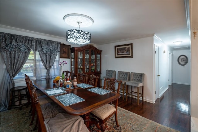 dining area with ornamental molding and dark hardwood / wood-style floors