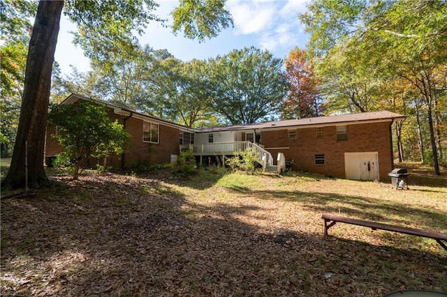 back of property with a wooden deck