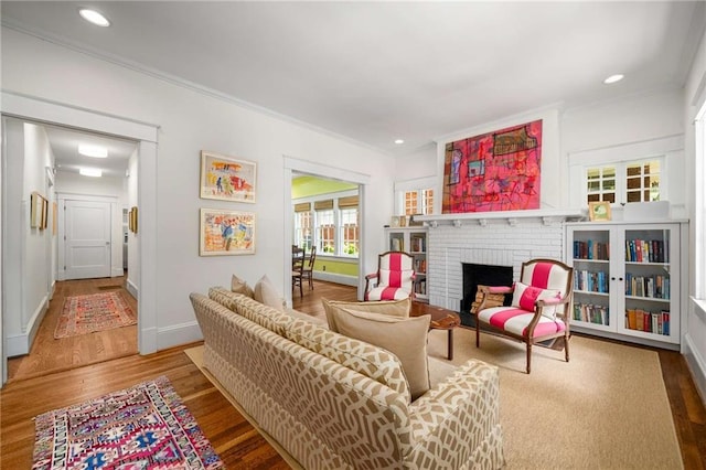 626 Elmwood Dr NE, Atlanta, GA 30306 - living room featuring crown molding, wood finished floors, a fireplace, and recessed lighting