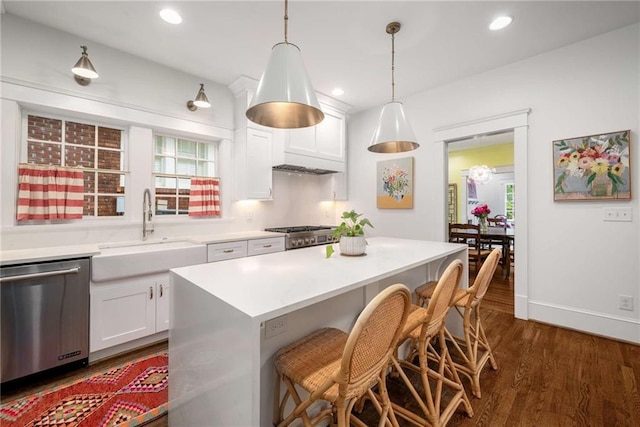 626 Elmwood Dr NE, Atlanta, GA 30306 - kitchen with dishwasher, a kitchen breakfast bar, dark wood-style floors, white cabinets, and light countertops