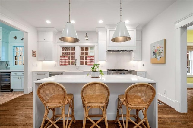 626 Elmwood Dr NE, Atlanta, GA 30306 - kitchen featuring beverage cooler, light countertops, dark wood-style flooring, white cabinets, and recessed lighting