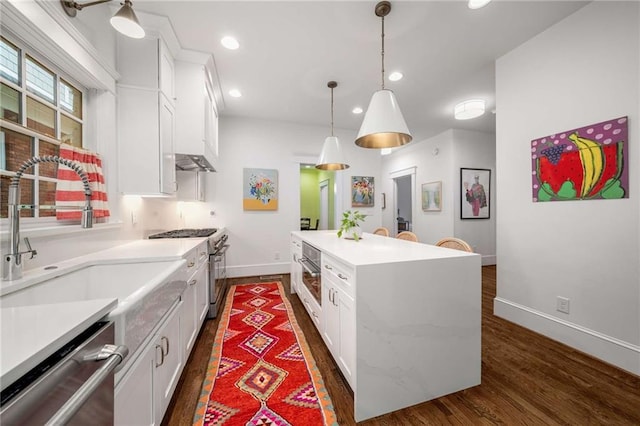 626 Elmwood Dr NE, Atlanta, GA 30306 - kitchen with stainless steel appliances, white cabinetry, dark wood-style flooring, a kitchen island, and recessed lighting