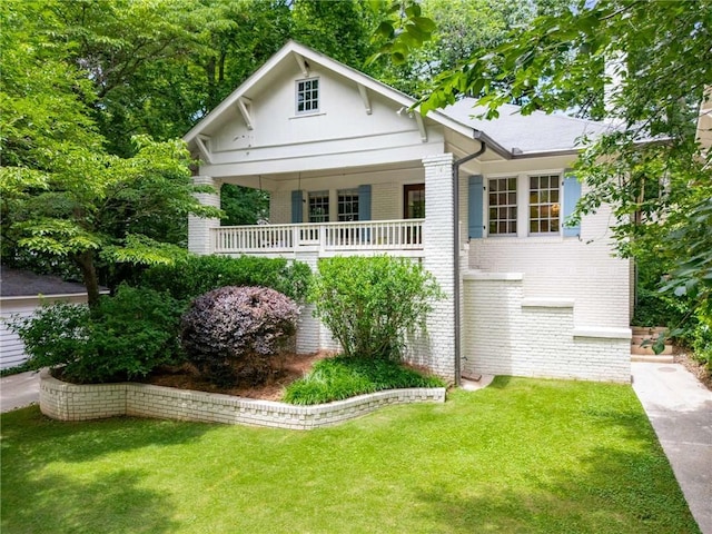 626 Elmwood Dr NE, Atlanta, GA 30306 - view of front of property with brick siding, a front yard, and covered porch