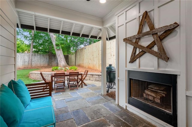 626 Elmwood Dr NE, Atlanta, GA 30306 - fenced backyard with an outdoor fireplace, outdoor dining area, and a patio