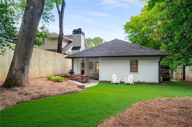 626 Elmwood Dr NE, Atlanta, GA 30306 - rear view of house featuring a fenced backyard, a shingled roof, a patio, and a chimney