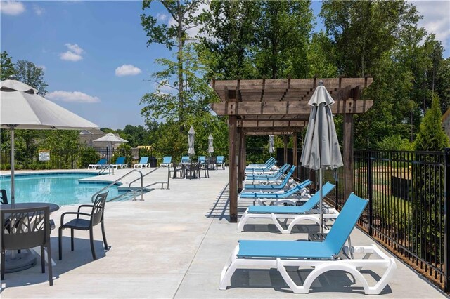 pool featuring fence and a patio area