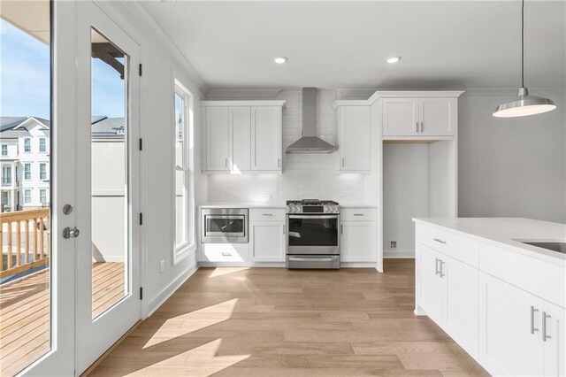 unfurnished living room with stairway, a stone fireplace, baseboards, and ceiling fan