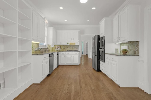 2010 Riverside Rd, Roswell, GA 30076 - kitchen featuring stainless steel appliances, white cabinets, dark stone countertops, open shelves, and ornamental molding