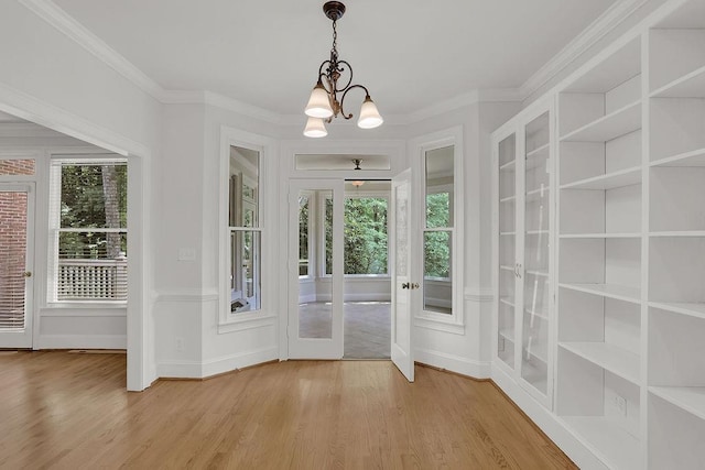 2010 Riverside Rd, Roswell, GA 30076 - entryway featuring plenty of natural light, wood finished floors, a chandelier, baseboards, and crown molding