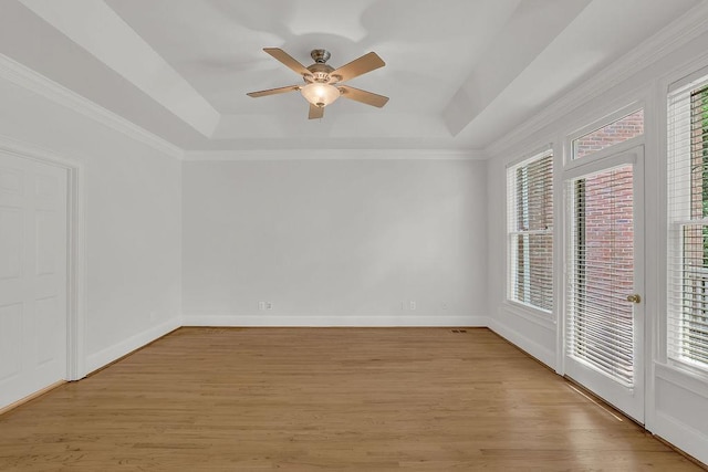 2010 Riverside Rd, Roswell, GA 30076 - empty room featuring a raised ceiling, healthy amount of natural light, a ceiling fan, and crown molding