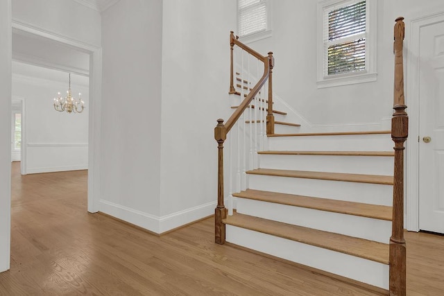 2010 Riverside Rd, Roswell, GA 30076 - staircase featuring crown molding, wood finished floors, plenty of natural light, and a chandelier