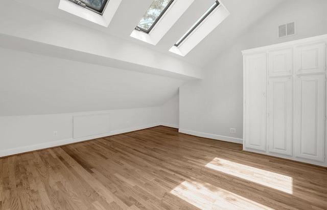 2010 Riverside Rd, Roswell, GA 30076 - bonus room with a skylight, vaulted ceiling, wood finished floors, and baseboards